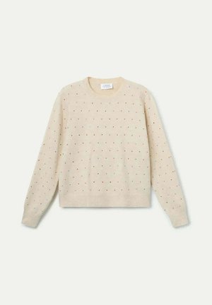 Suéter color crema con cuello redondo y mangas largas, con puntos multicolores distribuidos uniformemente por la tela. Textura suave.