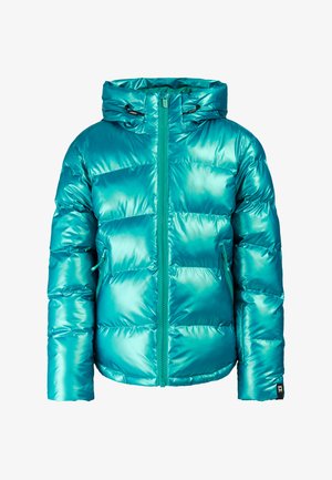 Young person wearing teal puffer jacket, patterned teal hoodie, black pants, black beanie, large orange sunglasses, and black platform shoes.