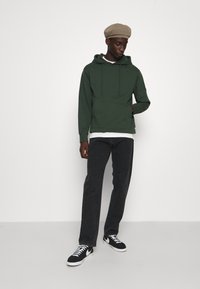 Carhartt WIP PONTIAC PANT MAITLAND - Straight leg jeans - black stone washed