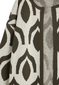 Knit garment featuring an abstract leaf pattern in dark green and cream. The texture is soft; the design is symmetrical with distinct outlines.