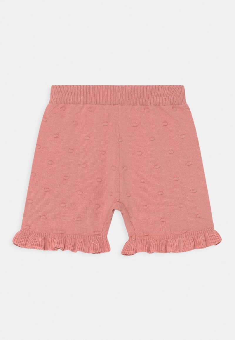 Calções de algodão cor-de-rosa com bainha volumosa, apresentando um padrão texturizado de pequenos pontos elevados. Cintura macia e elástica.