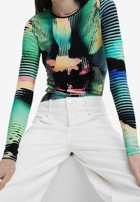 Langsleeve top met een levendig, abstract patroon in groen, zwart en regenboogkleuren; zachte, rekbare stof met een aansluitende pasvorm.