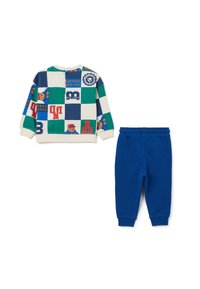 Ensemble en coton comprenant un pull à rayures multicolores avec des ours en cartoon et un pantalon de survêtement bleu assorti. Ceinture élastique sur le pantalon.