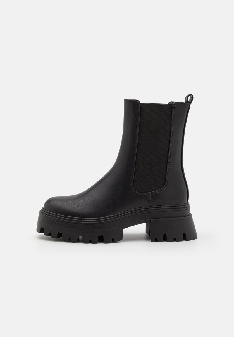 Black ankle boots with a chunky sole, composed of leather and elastic side panels. Features a pull tab at the heel for easy wearing.
