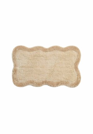 Tappetino da bagno rettangolare beige morbido con bordi smerlati e superficie testurizzata e soffice.