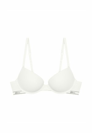 Biały stanik z fiszbinami, wykonany z gładkiego materiału, z delikatnie teksturowanymi miseczkami, regulowanymi ramiączkami oraz metką na obwodzie z nazwą marki napisaną kursywą.