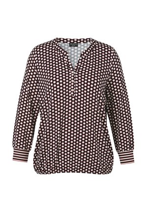 Schwarze Langarmbluse mit weißen Punkten, drei Knöpfen am Ausschnitt und gestreiften Manschetten.