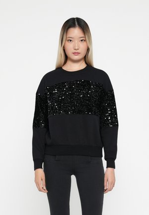 Felpa nera con un pannello orizzontale di paillettes sul petto, dal taglio morbido e con polsini a coste. Materiale morbido e design elegante.