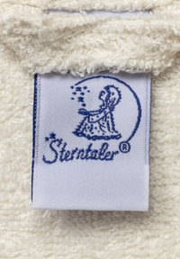 Tessuto bianco in spugna con una superficie testurizzata. Un'etichetta blu presenta la figura di un bambino e il marchio "Sterntaler" in corsivo.