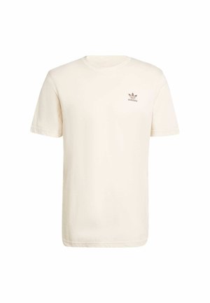 T-shirt in cotone color crema con maniche corte e scollatura a girocollo, caratterizzato da un piccolo logo Adidas marrone sul lato sinistro del petto.
