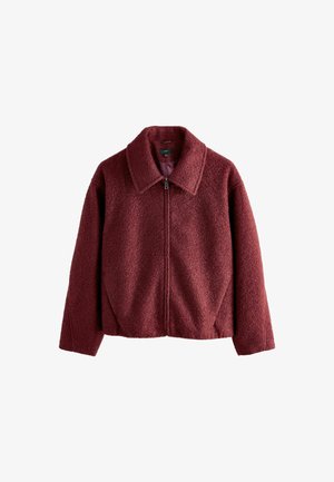 Giacca bordeaux con zip, in tessuto strutturato, maniche lunghe, colletto ampio e vestibilità leggermente accorciata.