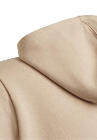 Beige hoodie featuring a soft, textured fabric, with a rounded hood and reinforced stitching for durability.