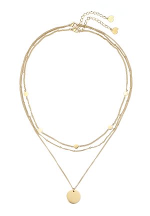 Delikatny, warstwowy złoty naszyjnik z małymi okrągłymi dyskami na górnych łańcuchach i większym okrągłym wisiorkiem na najdłuższym łańcuchu.