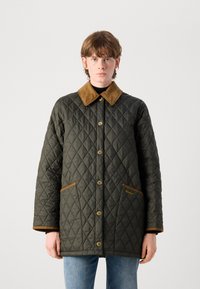 Gequiltte olijfgroene jas met een bruine corduroy kraag, gouden drukknoopjes en twee bruine accentenzakken, voorzien van een logo aan de voorkant.