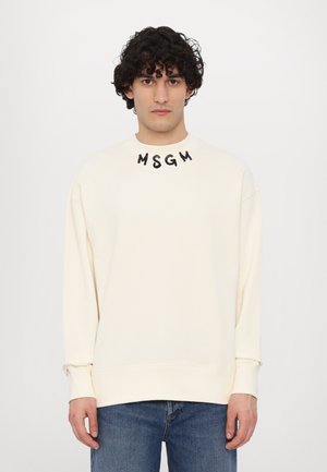 Sweatshirt couleur crème avec un col rond et le lettrage noir "MSGM" au niveau du col, présentant une coupe décontractée et des poignets côtelés.