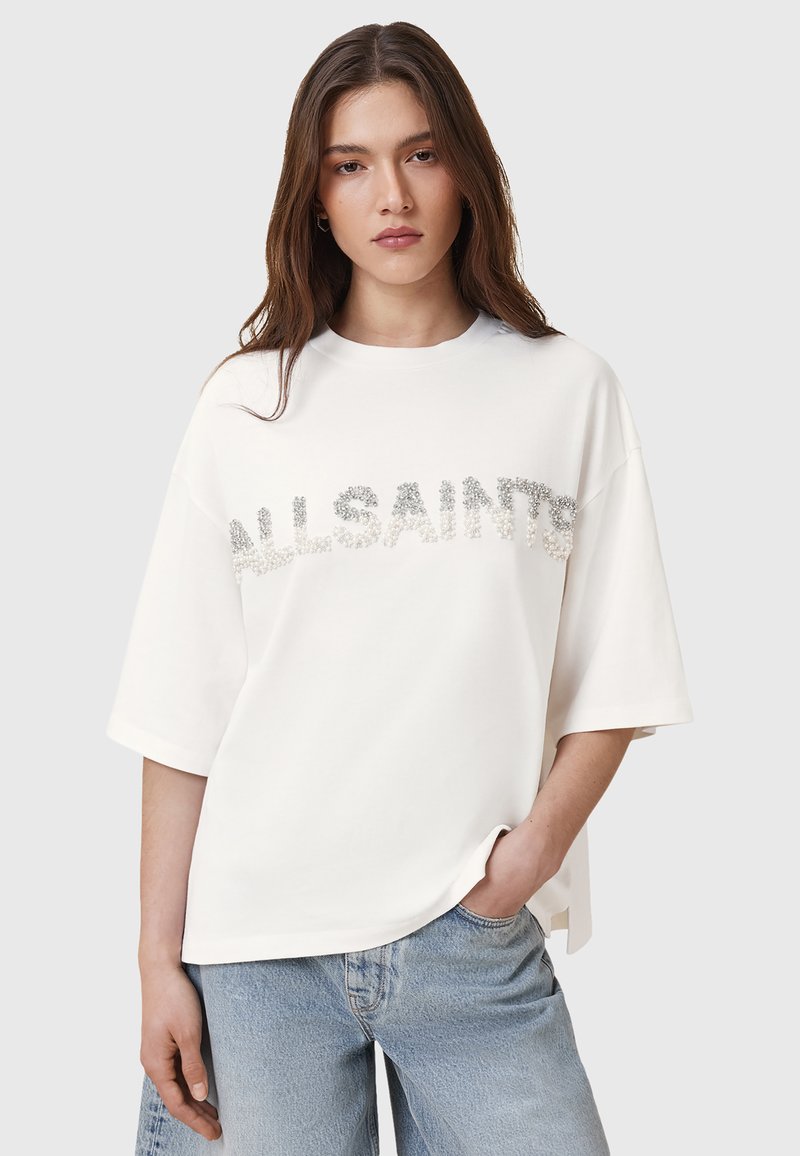 T-shirt in cotone bianco con maniche corte oversize, con logo "ALLSAINTS" in paillettes argento sulla parte anteriore; vestibilità rilassata, scollo a girocollo.