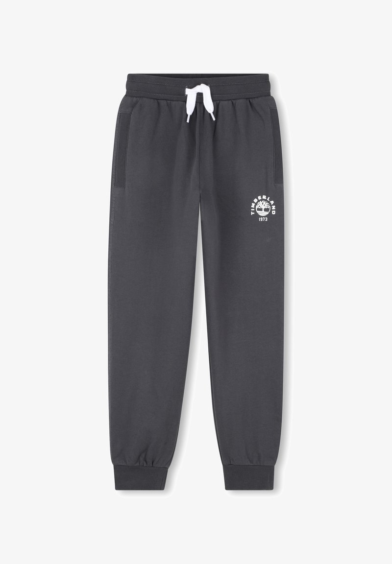 Pantalon de jogging gris foncé avec poignets élastiques, cordon de serrage blanc, poches latérales, et logo Timberland blanc sur la cuisse gauche.