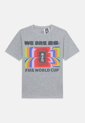 Grey T-shirt with colorful rectangular design, FIFA World Cup trophy silhouette, and text "WE ARE 26" and "FIFA WORLD CUP" on front.