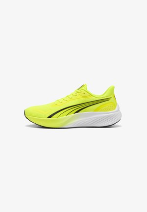 Neon yellow athletic shoe with breathable mesh upper, black accents, and a textured white midsole. Features laces and padded collar.