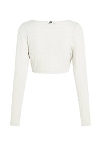 Λευκό μακρυμάνικο cropped τοπ με σχέδιο Chevron, με φαρδιά λαιμόκοψη και λεπτομέρεια κουμπιών στο πίσω μέρος. Λείο ύφασμα.