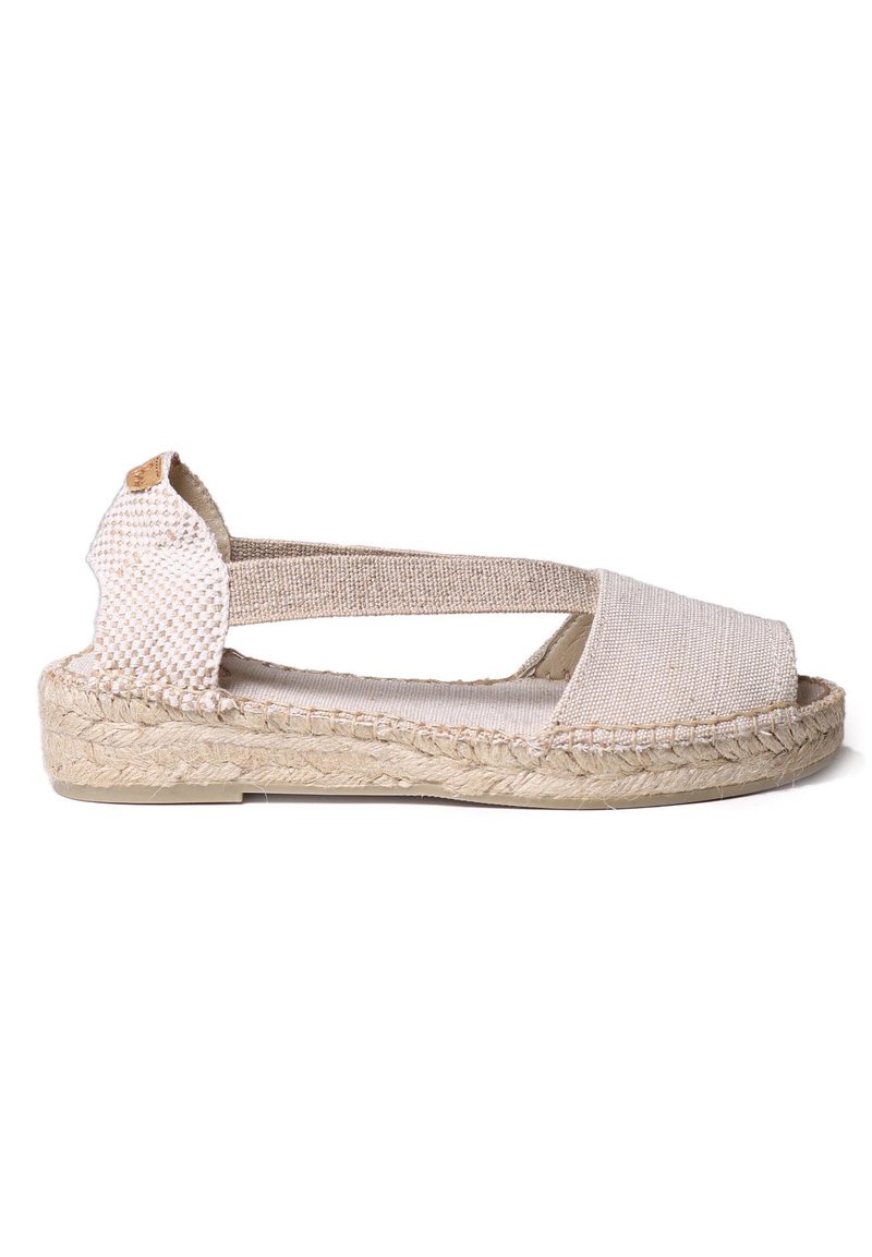 Beige espadrille sandal featuring a canvas upper, open toe, crisscross elastic straps, and woven jute sole with textured detailing.