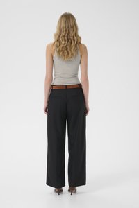 Light gray tank top paired with black wide-leg trousers and a brown belt. Smooth texture, plain design with four pockets.