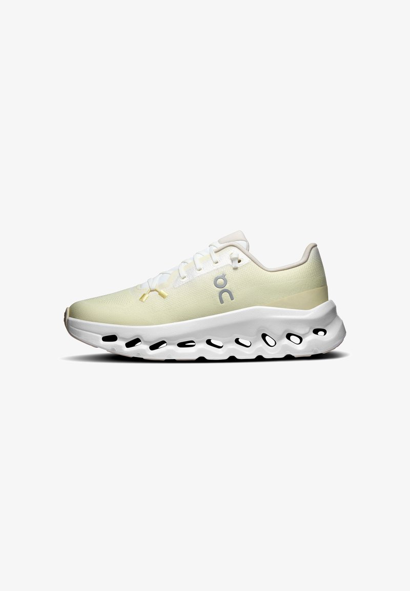 Chaussure de course basse beige clair avec semelle blanche comportant plusieurs découpes ovales et le logo de la marque "on" gris sur le côté.