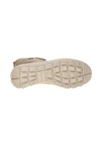 Helle beige Gummistiefelsohle mit einem strukturierten Profilmuster, das tiefe Rillen und einen flachen Absatz für Traktion und Stabilität aufweist.