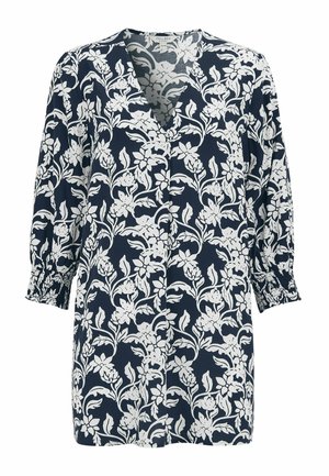 Laivastonsininen tunika valkoisella kukkakuviolla, v-pääntiellä, kolmen neljänneksen pituusisillä liehuvilla hihoilla, joissa on smokkaukset hihansuissa, väljä istuvuus.