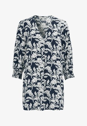 Marineblå tunika med hvidt blomsterprint, V-udskæring, trekvartlange puff-ærmer med smocked manchetter, løs pasform.