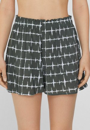 Šortky - schwarz y stampa shibori safari green