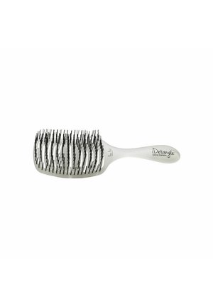 Detangling brush with a white plastic handle and a rectangular barrel. Features black bristles in varying lengths for effective untangling.
