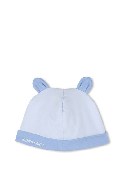 Bonnet en coton bleu clair avec des oreilles arrondies, bord replié, et texte "KENZO PARIS" en blanc. Texture douce, design sans couture.