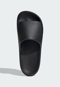 Black slide sandal with textured upper strap, flat design, and cushioned footbed. Features embossed logo on side and smooth surface.