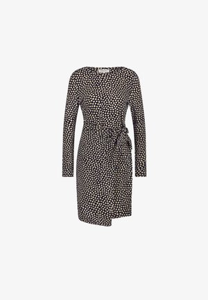 Long-sleeve wrap dress in navy with a tan polka dot pattern, featuring a tie at the waist and a knee-length hem. Soft fabric texture.