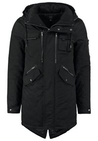 Svart parka-jacka med avtagbar huva, flera dragkedjefickor, lång nederkant och en strukturerad yta. Kopparfärgade detaljer på hårdvaran.