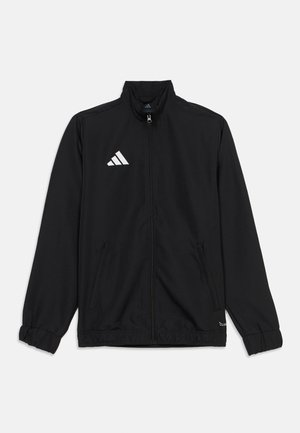 Must must täislukuga spordijakk kõrge kraega, elastsete mansettide, küljetaskute ja vasakul rinnal valge Adidas logo.