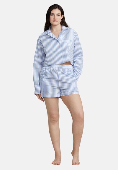 Blue and white striped pajama set featuring a cropped button-up shirt with a pocket and elastic waist shorts. Soft cotton fabric.
