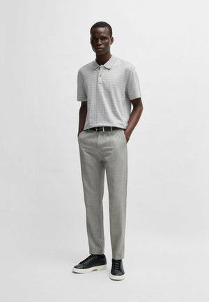 Gray short-sleeve polo with a subtle pattern, paired with light gray tailored trousers and black sneakers, featuring a sleek black belt.