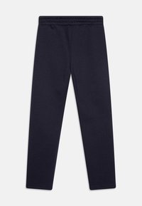 Marineblaue Leggings aus weichem, dehnbarem Material mit einem breiten Bund und ohne sichtbare Nähte oder Muster, die für Komfort und Bewegungsfreiheit entworfen wurden.