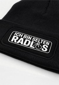 Black ribbed beanie featuring a rectangular black patch with white text reading "ICH BIN SELTEN RADLÖS" and a bicycle graphic.