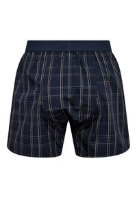 Mørkeblå boxershorts med et gittermønster i beige, lavet af letvægtsstof med en elastisk talje for komfort og pasform.