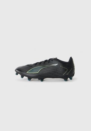 Black soccer cleat with textured upper, green accents, and tapered toe design. Features a low profile and conical studs for traction.