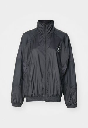 Veste zippée noire avec un col haut, des poignets élastiqués et une taille froncée. Fabriquée en tissu léger et lisse avec un détail de logo.