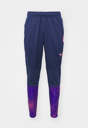 Marineblauwe sportbroeken met een fitted ontwerp, paarse accenten op de onderbenen die een textuurverloop patroon hebben, elastische tailleband.