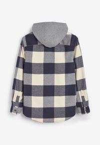 Gecheckte flanellen overhemd in marineblauw, crème en grijs. Beschikt over een grijze capuchon, knoopmanchetten en een gebogen zoom. Zachte textuur met contrasterende patronen.