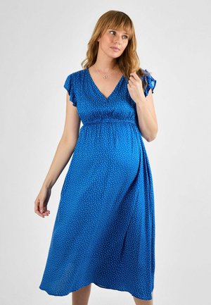 Blue polka dot dress with short ruffled sleeves, V-neckline, elastic waistband, and ankle-length hem. Soft fabric with a lightweight texture.