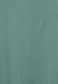Teal fabric with a smooth texture and diagonal weave pattern, showcasing a consistent hue without notable accents or designs.