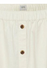 Beige Shorts mit elastischem Bund, featuring einen Frontknopfverschluss und subtilen vertikalen Nahtdetails. Glattes, leichtes Material.