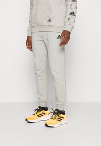 adidas Performance - ESSENTIALS TAPERED - Tréningruha alsók - medium grey heather/black Miniatűr kép 1